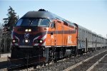 Outbound commuter approaches the station behind the Milwaukee Road heritage unit